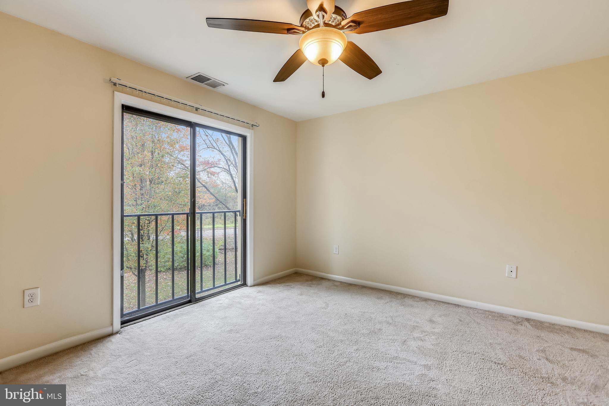 2572 Riva Road, Unit 9B Annapolis, MD 21401 - Photo 20 of 36 an empty room with chandelier fan and windows