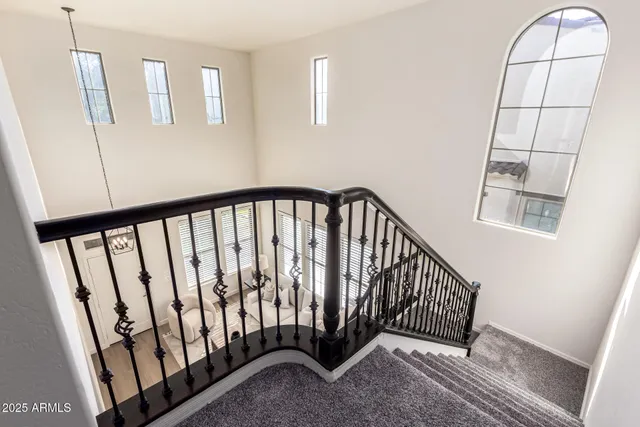 a bedroom with a bed and a lamp on the dresser