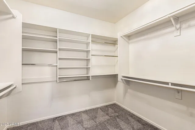 an empty room with ceiling fan and window