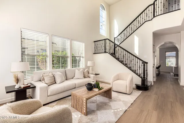 a living room with furniture and floor to ceiling windows