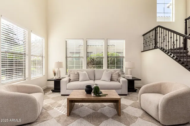 a living room with furniture flat screen and a window