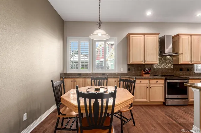 a view of a a dining room with furniture window and wooden floor