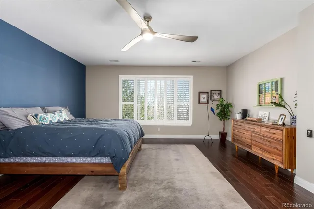 a living room with a bed furniture and a potted plant