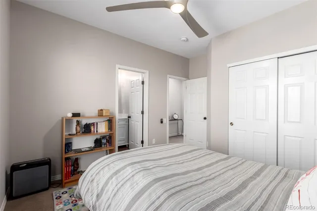 a bedroom with a bed and a large mirror