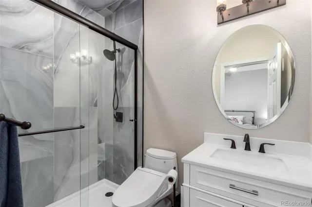a bathroom with a sink a toilet and a mirror