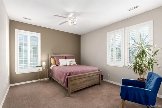 a spacious bedroom with a bed and a couch