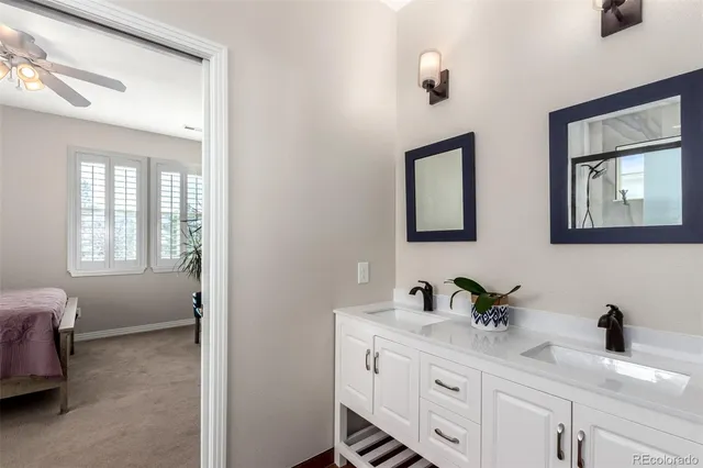 a bathroom with a double vanity sink and a mirror
