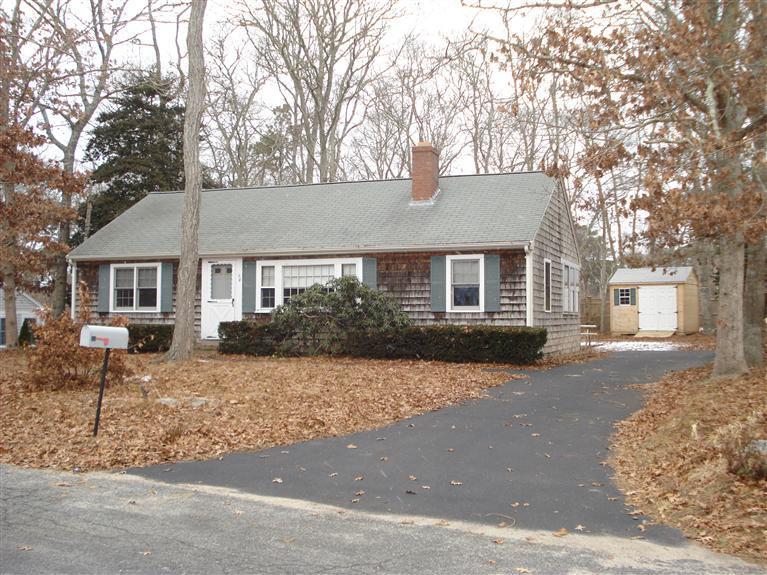 94 Harbor Hills Road Centerville, MA 02632 - Photo 1 of 10 a front view of a house with a yard