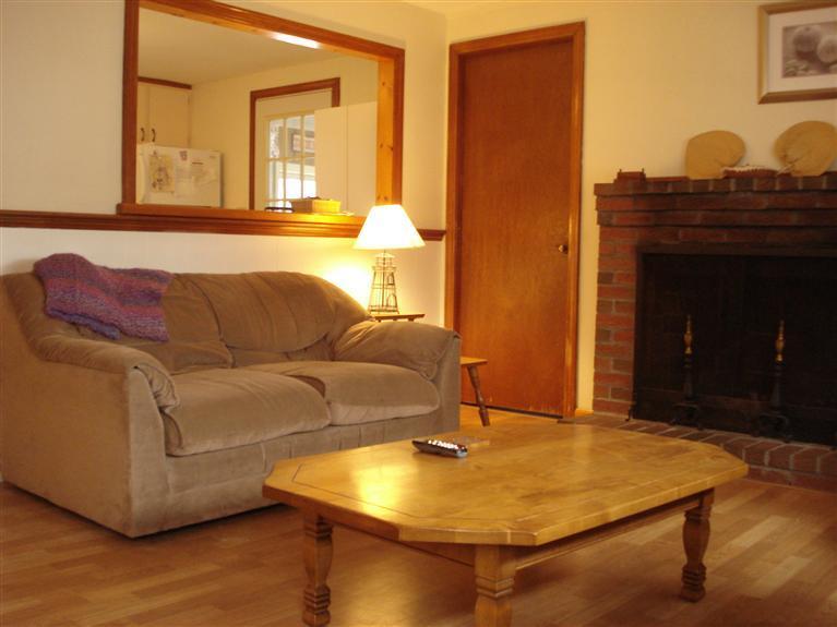 94 Harbor Hills Road Centerville, MA 02632 - Photo 2 of 10 a living room with a couch and chandelier