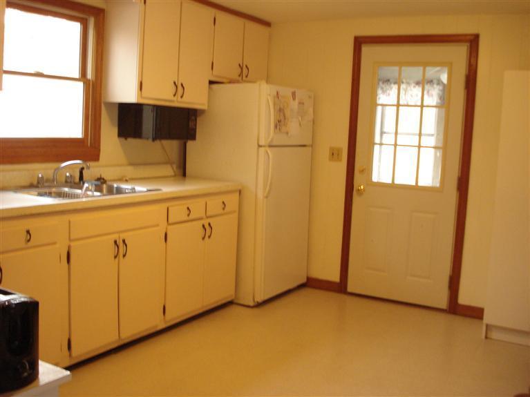 94 Harbor Hills Road Centerville, MA 02632 - Photo 3 of 10 a kitchen with a sink a refrigerator and cabinets
