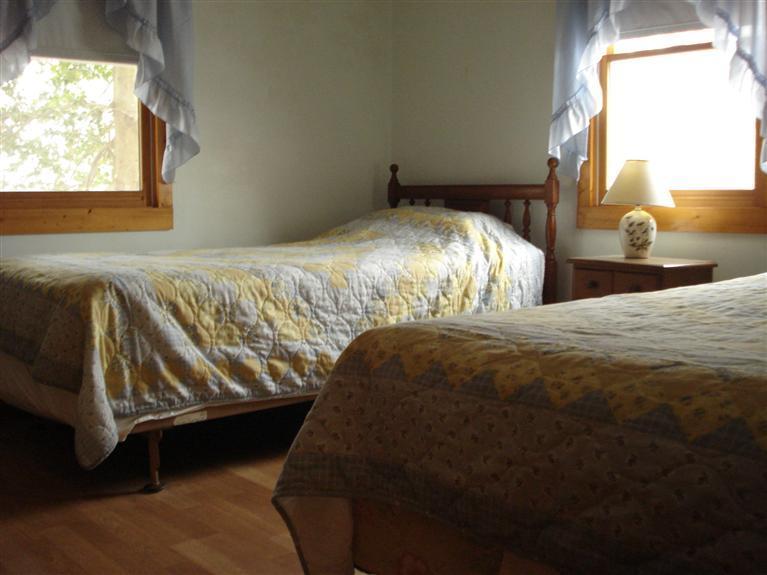 94 Harbor Hills Road Centerville, MA 02632 - Photo 5 of 10 a bedroom with a bed next to a window