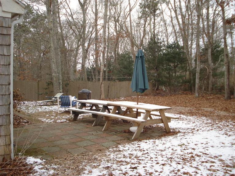 94 Harbor Hills Road Centerville, MA 02632 - Photo 9 of 10 a backyard of a house with table and chairs