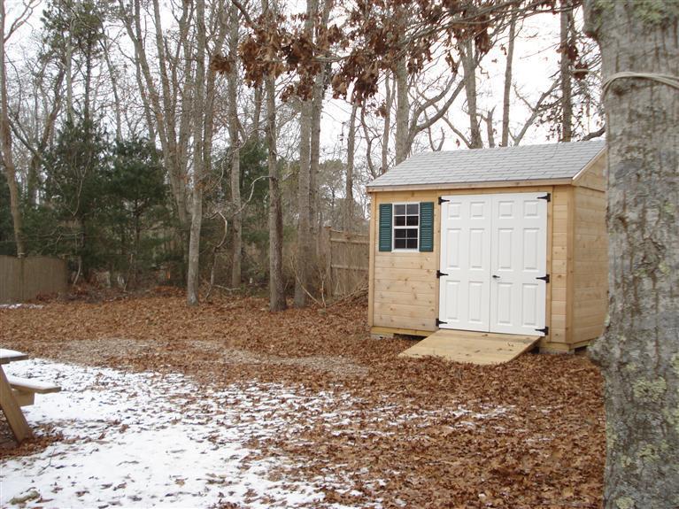 94 Harbor Hills Road Centerville, MA 02632 - Photo 10 of 10 a view of a house with a large tree and wooden fence