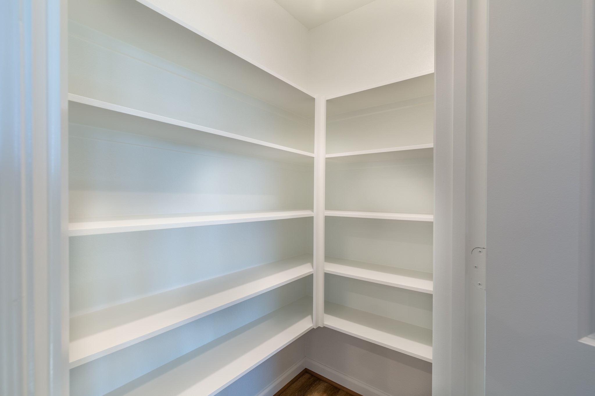 203 Park Place Circle, Unit D Waller, TX 77484 - Photo 12 of 29 a view of walk in closet with empty racks