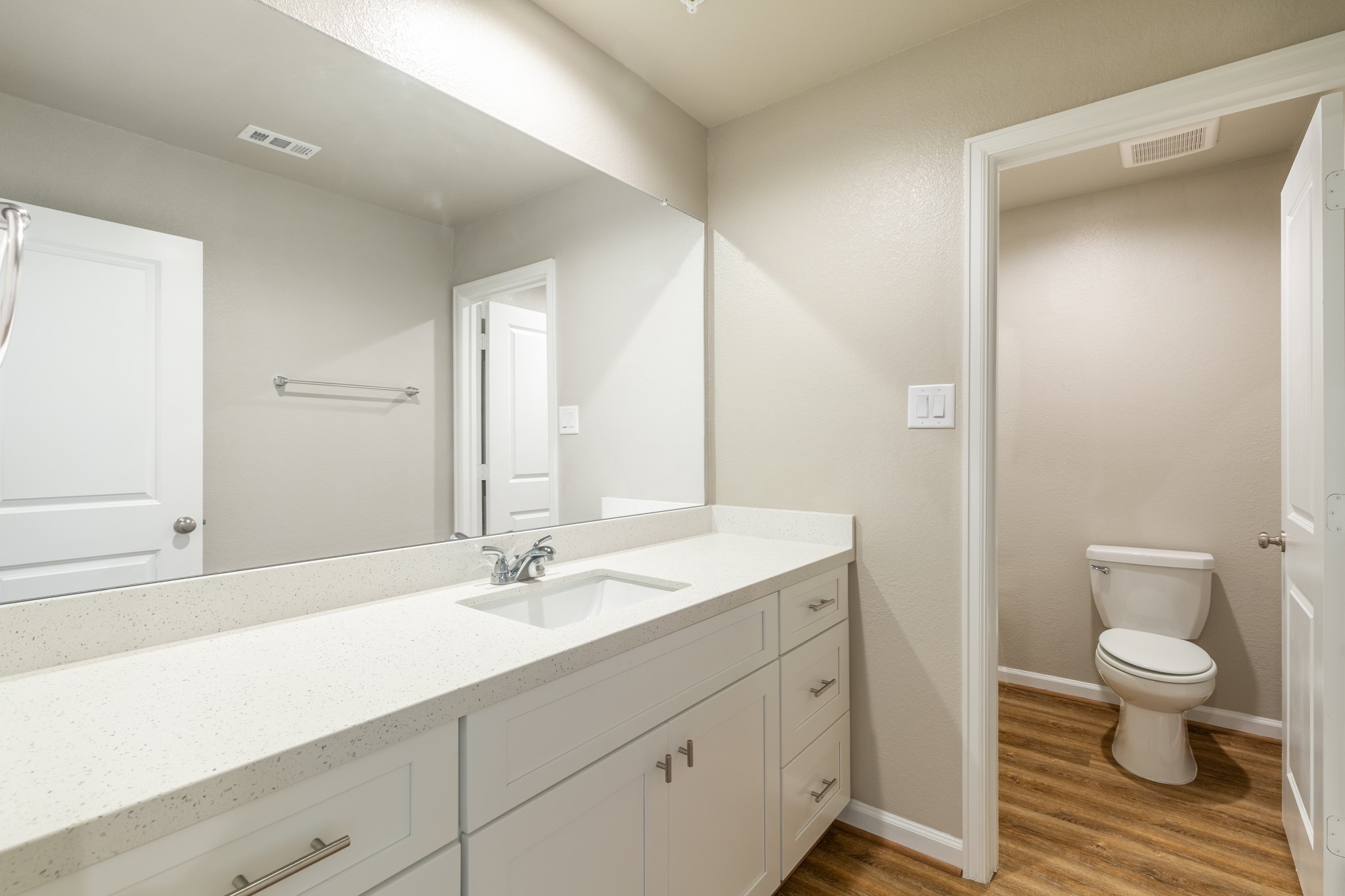 203 Park Place Circle, Unit D Waller, TX 77484 - Photo 14 of 29 a bathroom with a sink a toilet and a large mirror