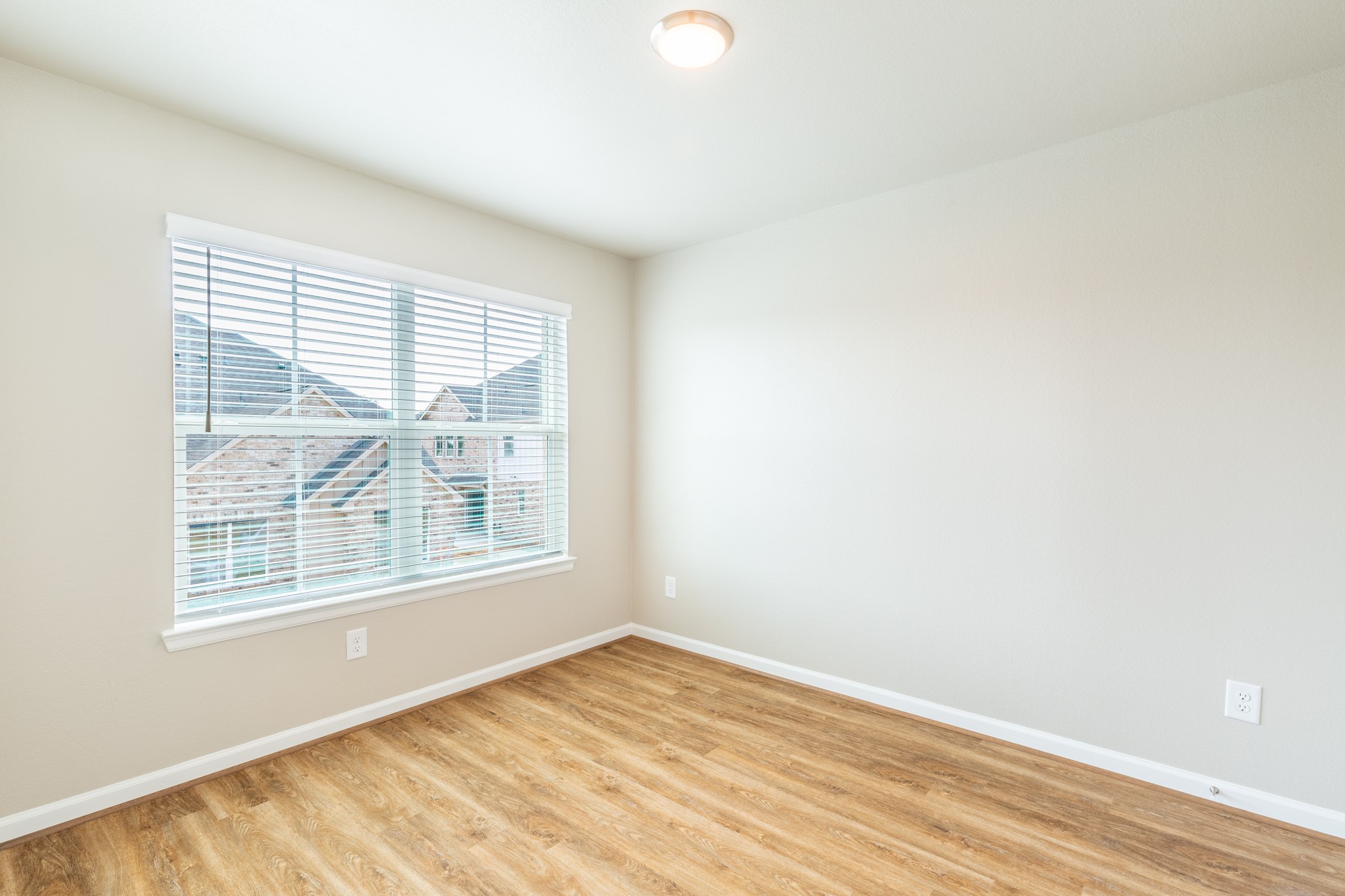 203 Park Place Circle, Unit D Waller, TX 77484 - Photo 24 of 29 an empty room with wooden floor and windows