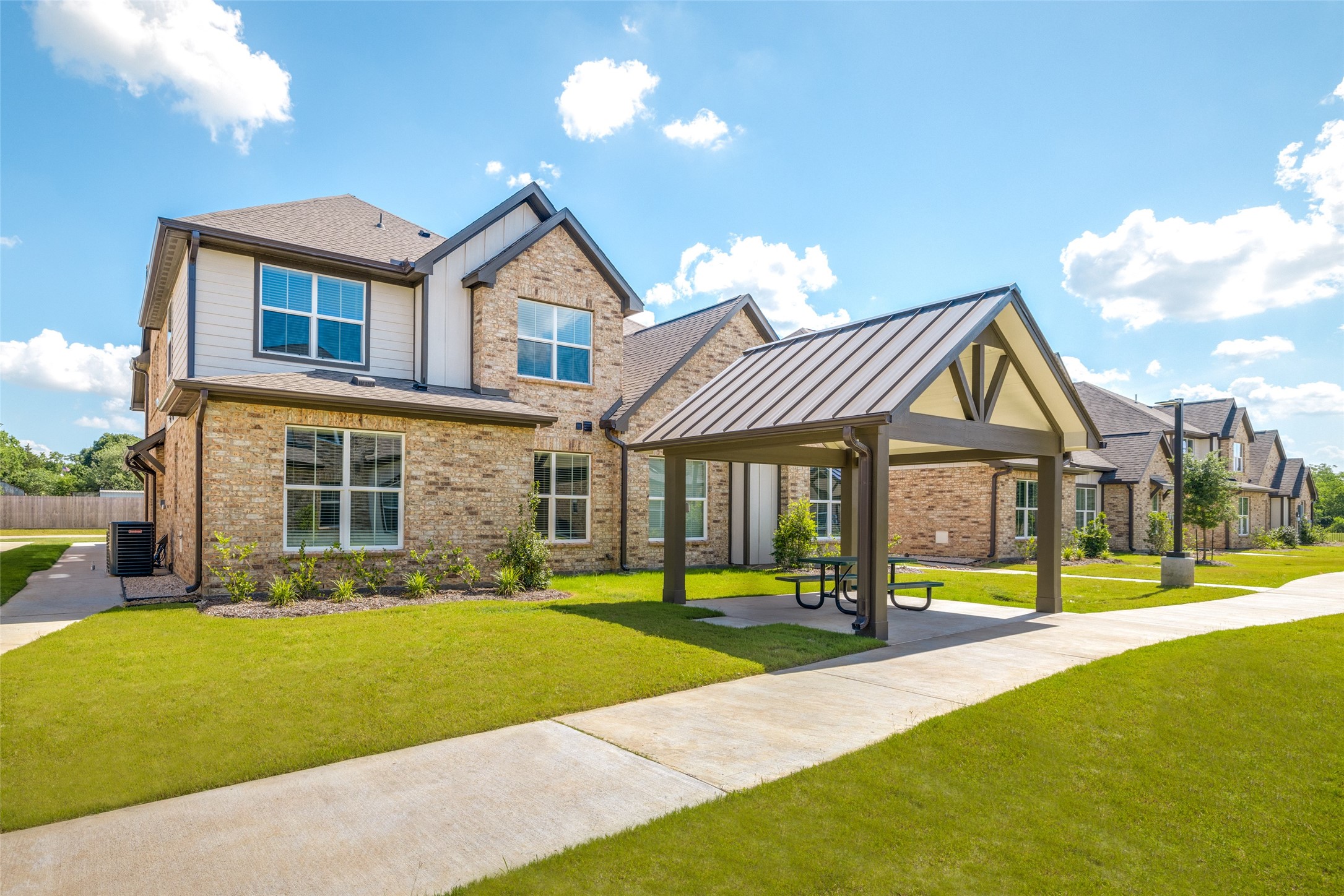 203 Park Place Circle, Unit D Waller, TX 77484 - Photo 27 of 29 a front view of a house with a yard