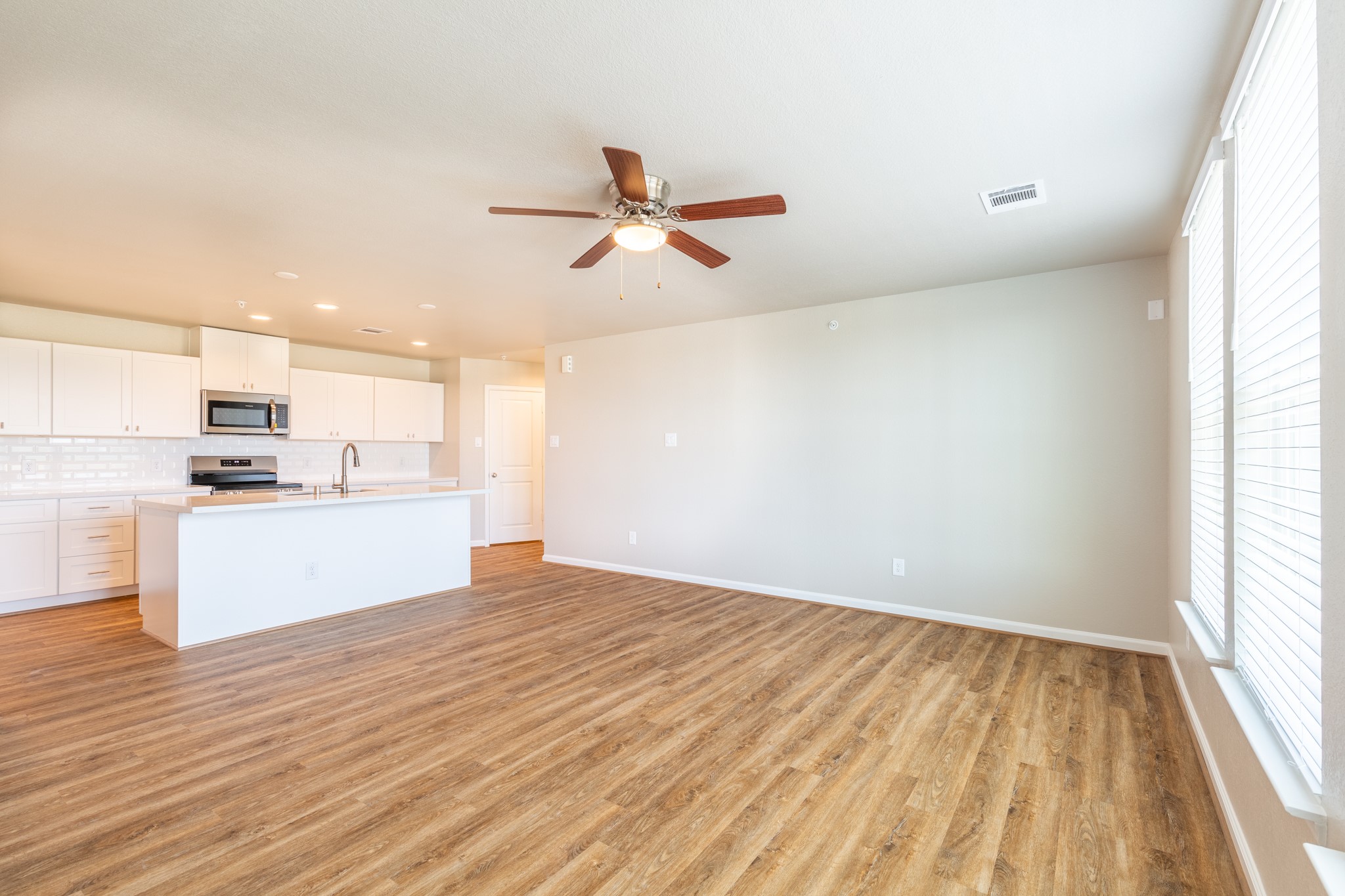 203 Park Place Circle, Unit D Waller, TX 77484 - Photo 6 of 29 a view of kitchen with wooden floor and window