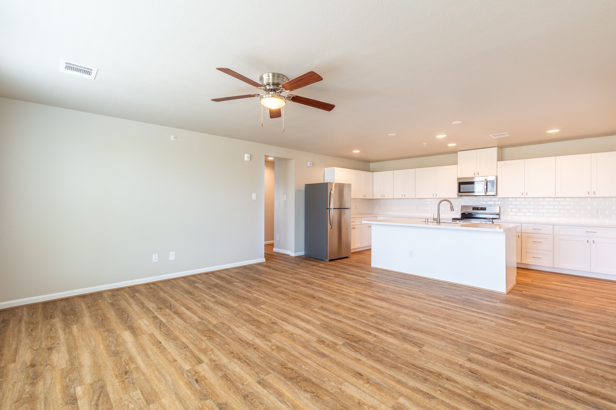 203 Park Place Circle, Unit D Waller, TX 77484 - Photo 8 of 29 a view of a kitchen with a sink and refrigerator