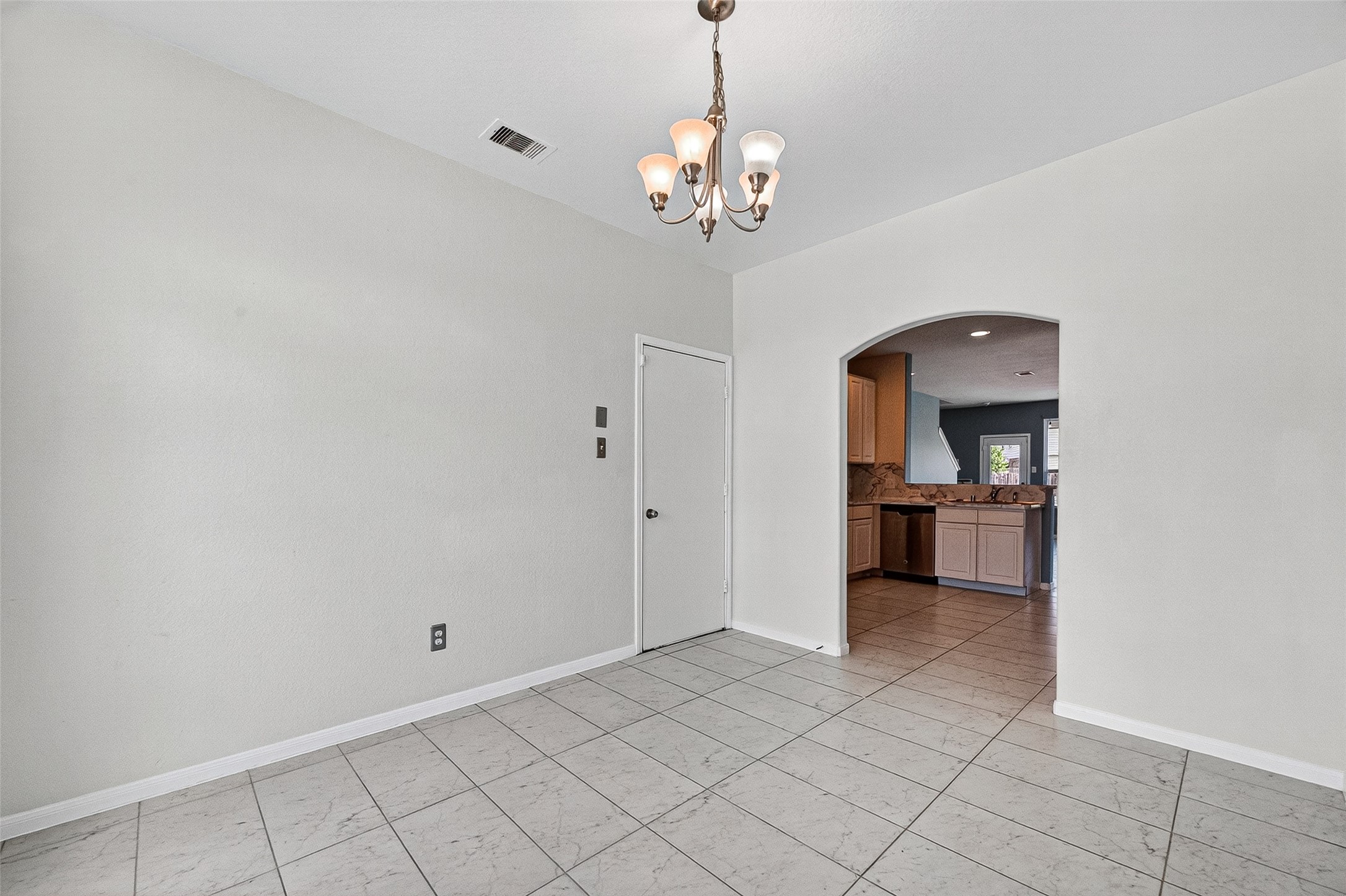 2702 Modano Court Fresno, TX 77545 - Photo 12 of 46 a view of a hallway with a chandelier and a living room
