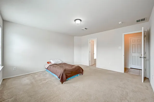 a living room with a bed and a cabinets