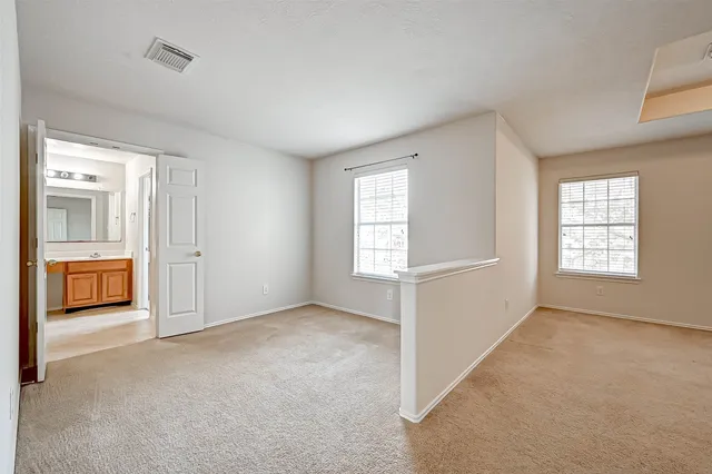 an empty room with windows and closet
