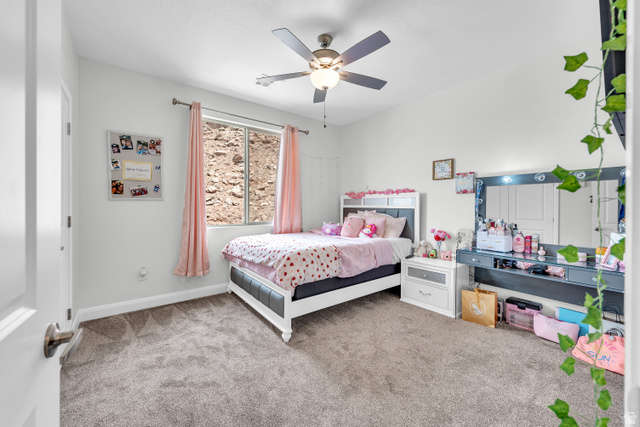 6105 Bunda Way St. George, UT 84790 - Photo 25 of 49 Carpeted room with a ceiling fan, a window with natural light, and ample wall space