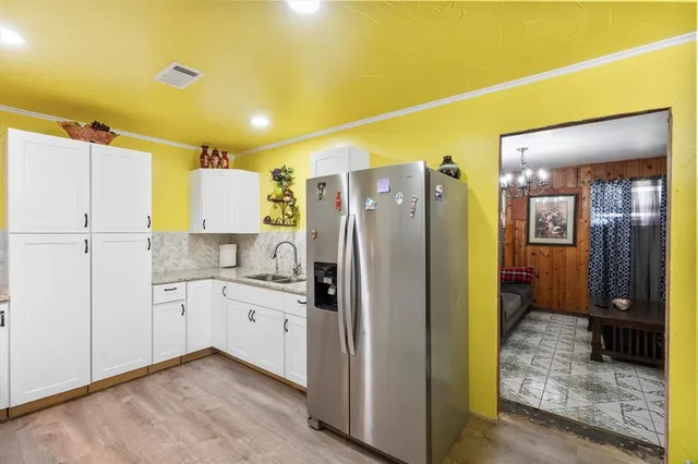 a kitchen with stainless steel appliances a refrigerator and cabinets