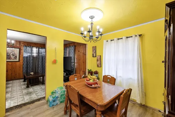 a view of a dining room with furniture and a chandelier