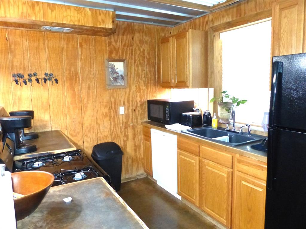 101 South Loop Drive Brady, TX 76825 - Photo 12 of 34 a kitchen with a sink and a large window
