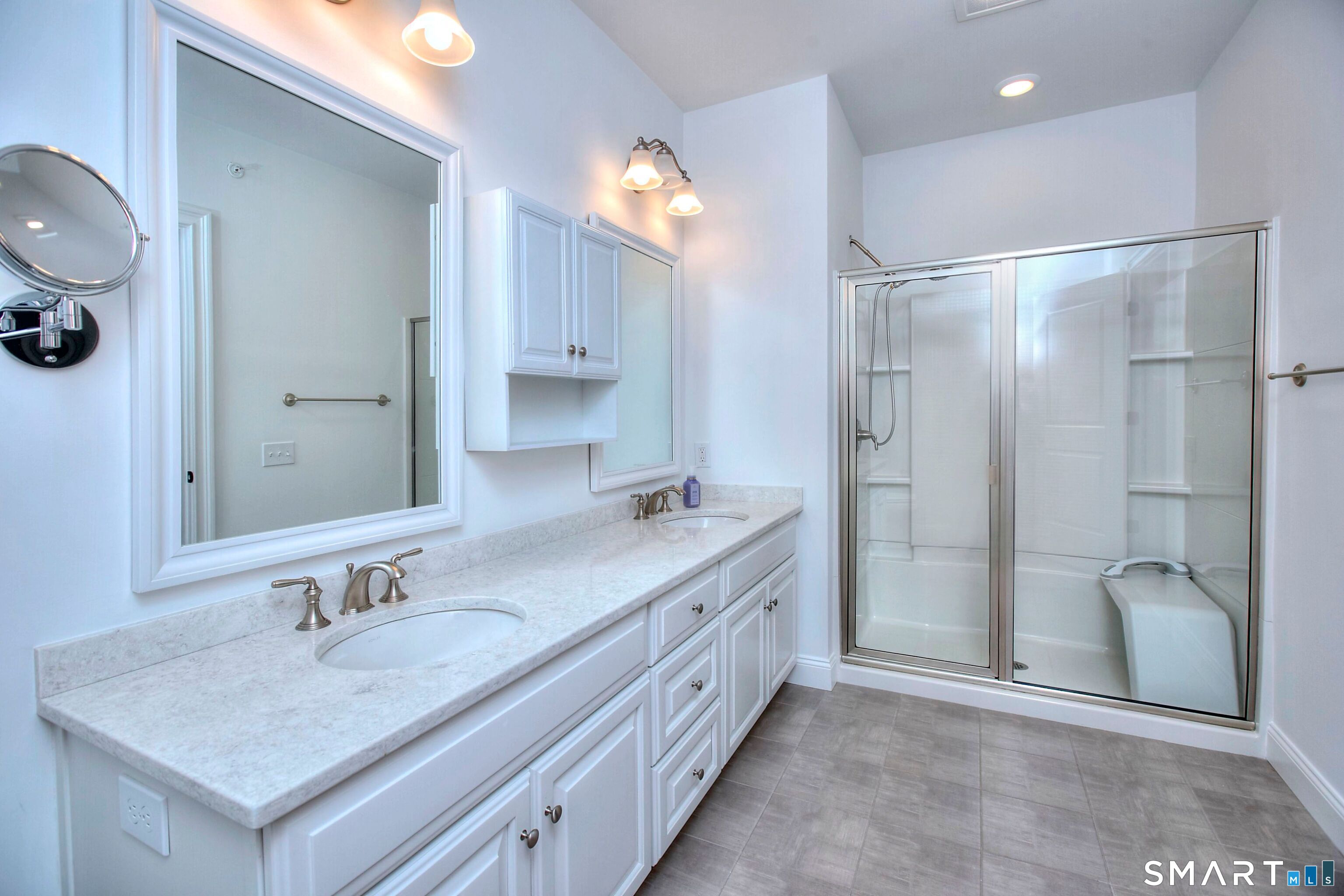 77 Sunset Lane, Unit 335 Ridgefield, CT 06877 - Photo 11 of 25 a bathroom with a double vanity sink mirror and shower
