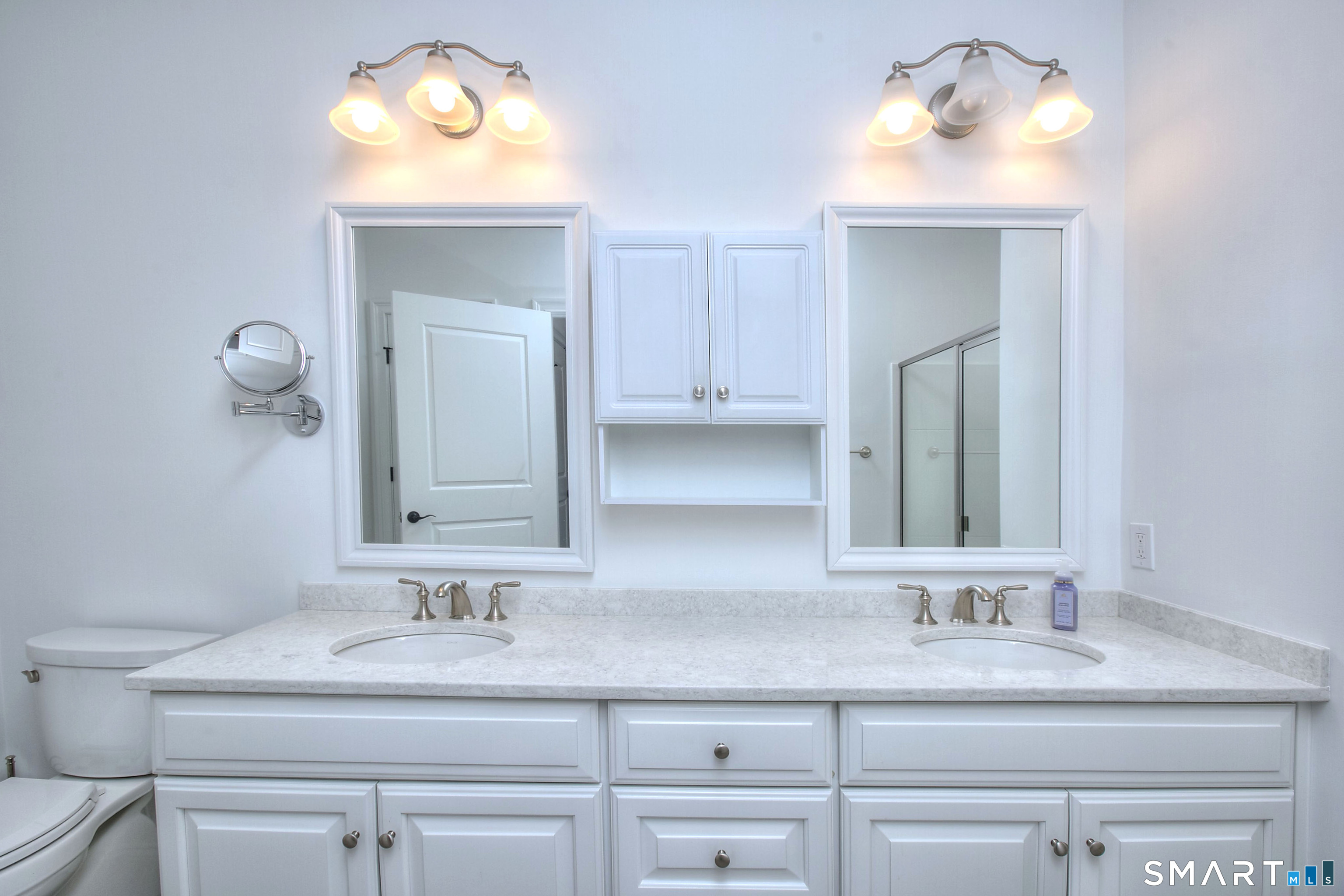 77 Sunset Lane, Unit 335 Ridgefield, CT 06877 - Photo 12 of 25 a bathroom with a sink vanity and mirror