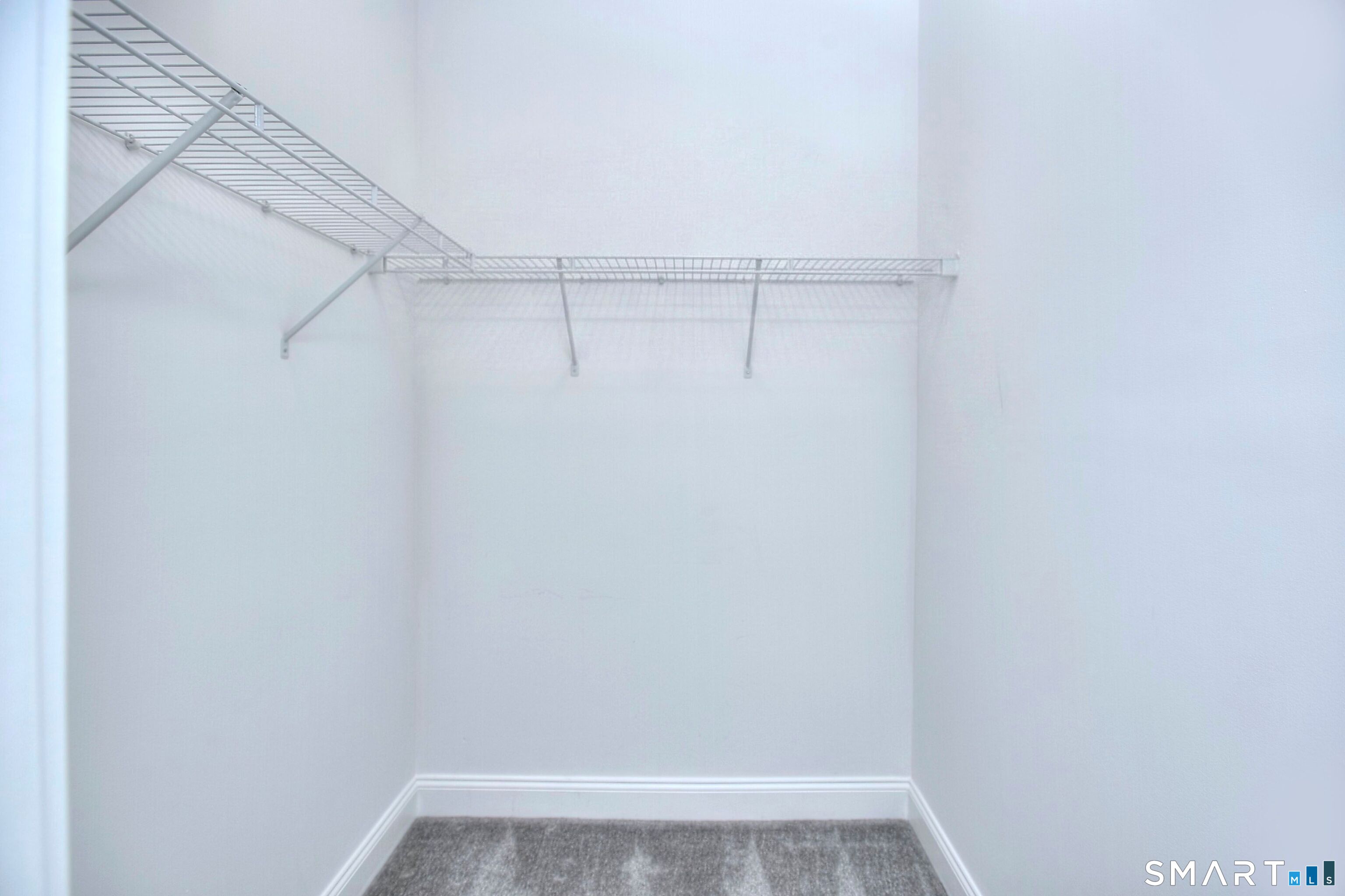 77 Sunset Lane, Unit 335 Ridgefield, CT 06877 - Photo 13 of 25 a view of a room with racks on the wall