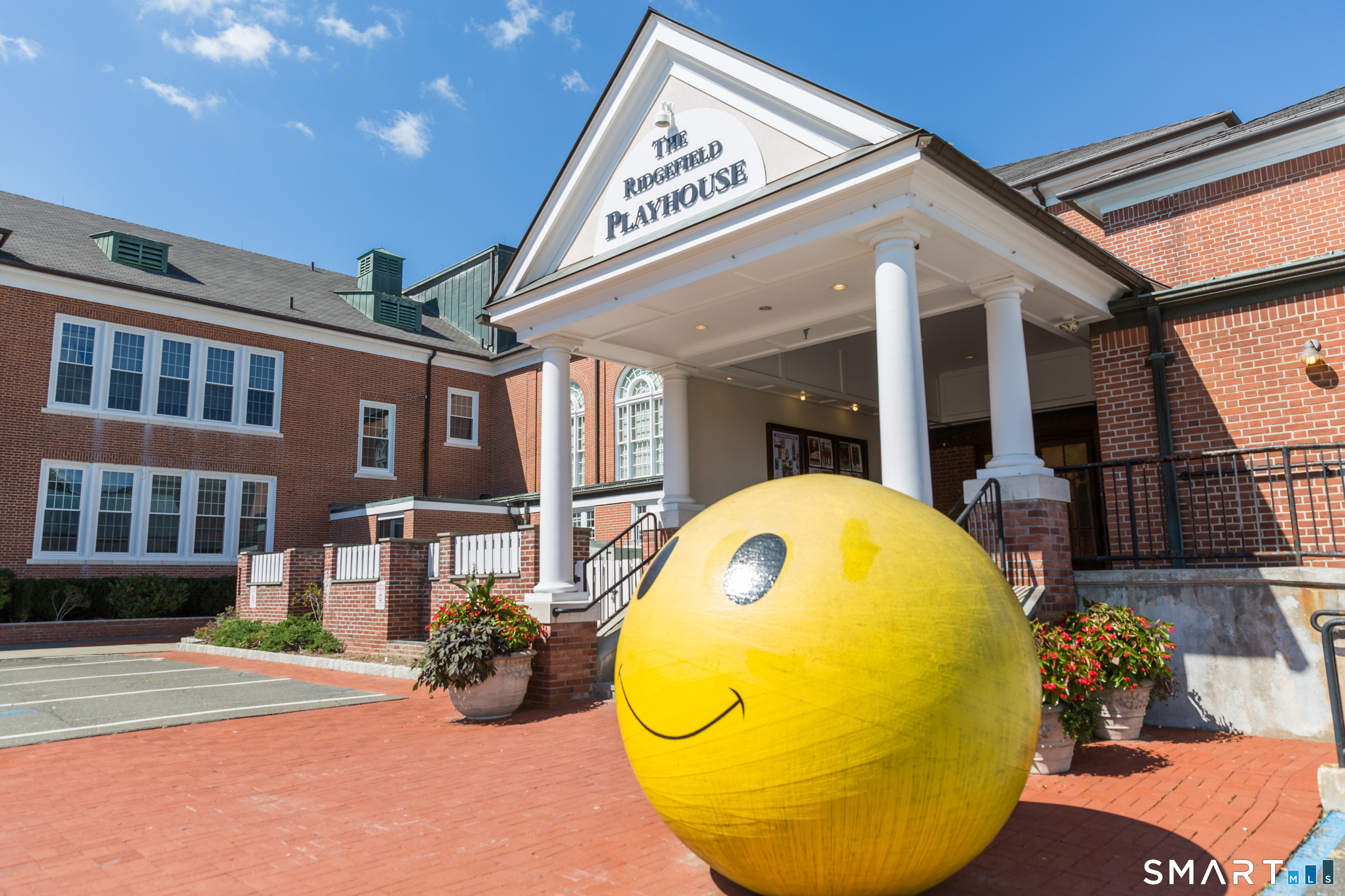 77 Sunset Lane, Unit 335 Ridgefield, CT 06877 - Photo 23 of 25 a view of a patio with table and chairs potted plants and wooden floor
