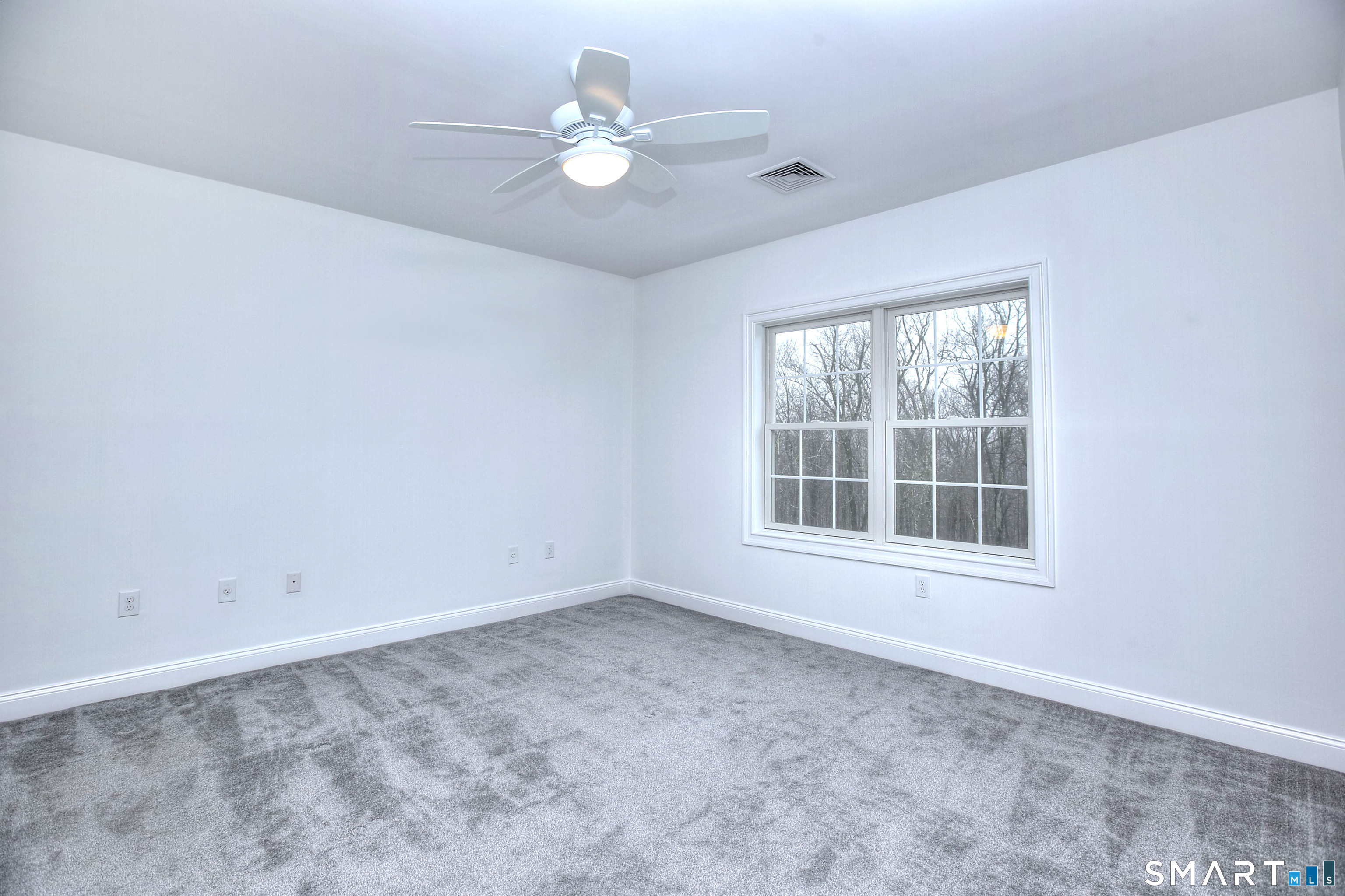 77 Sunset Lane, Unit 335 Ridgefield, CT 06877 - Photo 9 of 25 an empty room with windows and ceiling fan