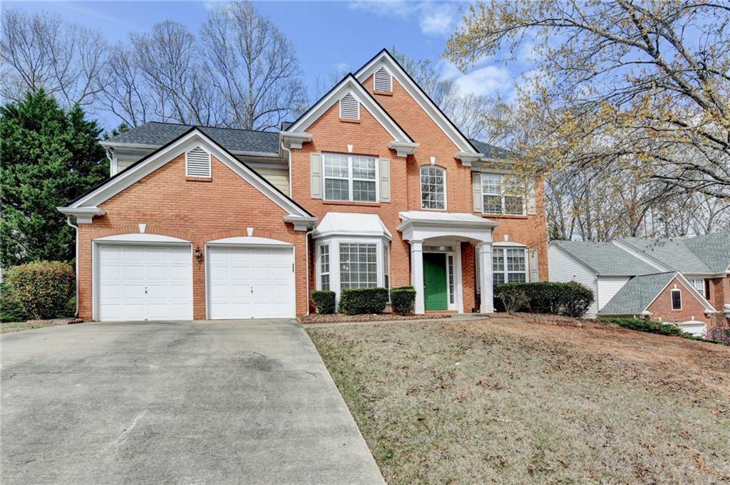 100 Hawnley Trc Northwest Suwanee, GA 30024 - Photo 2 of 58 a front view of a house with a yard and garage