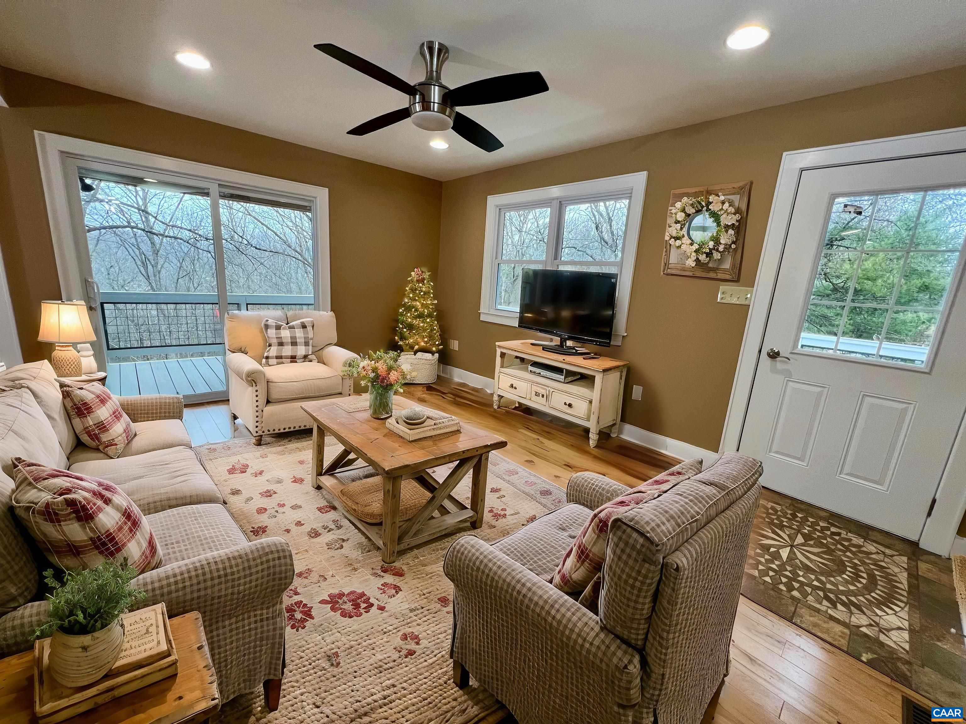 8272 Faber Road Faber, VA 22938 - Photo 13 of 44 a living room with furniture a flat screen tv and a large window