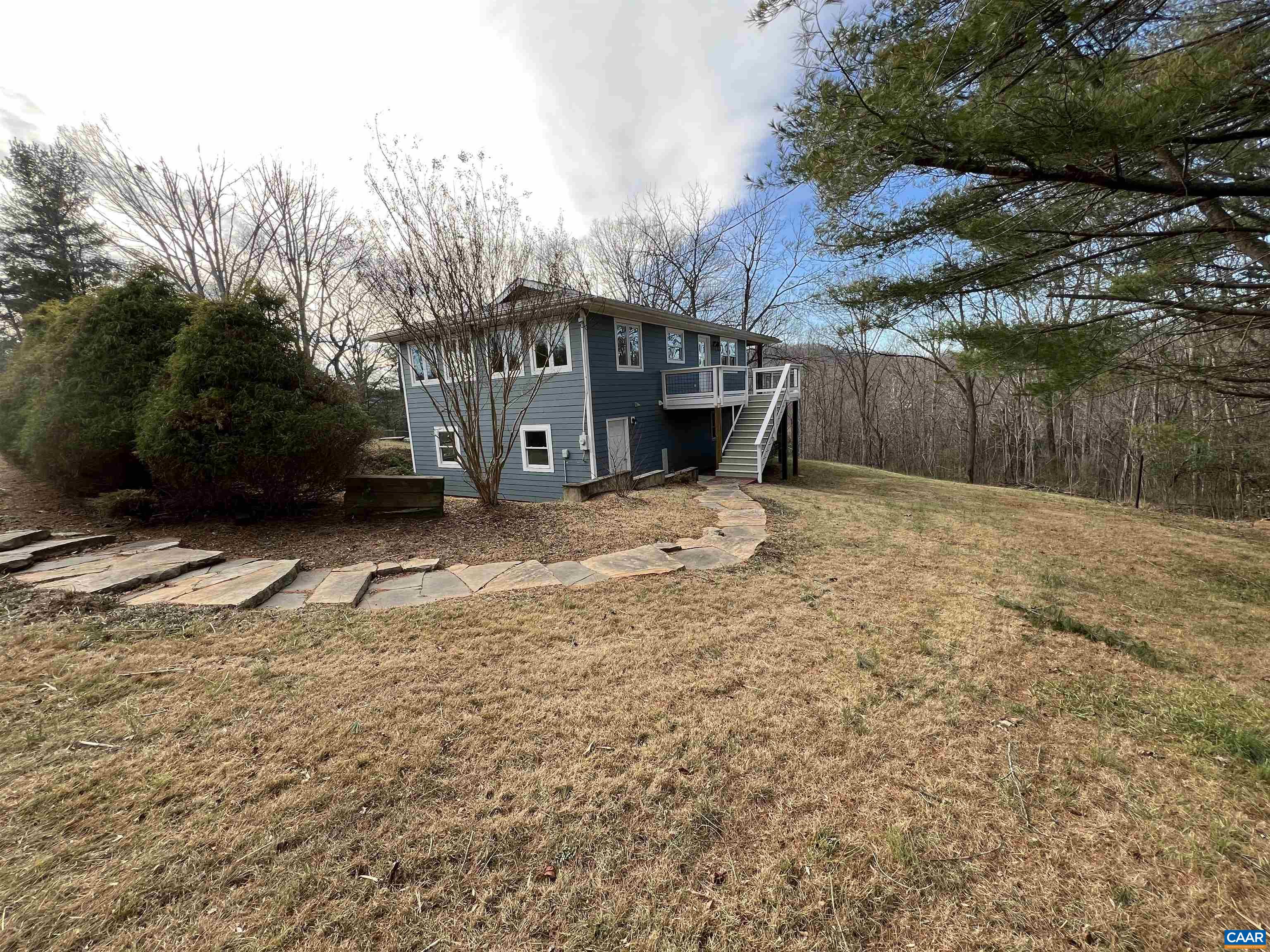 8272 Faber Road Faber, VA 22938 - Photo 39 of 44 a backyard of a house with large trees and wooden fence