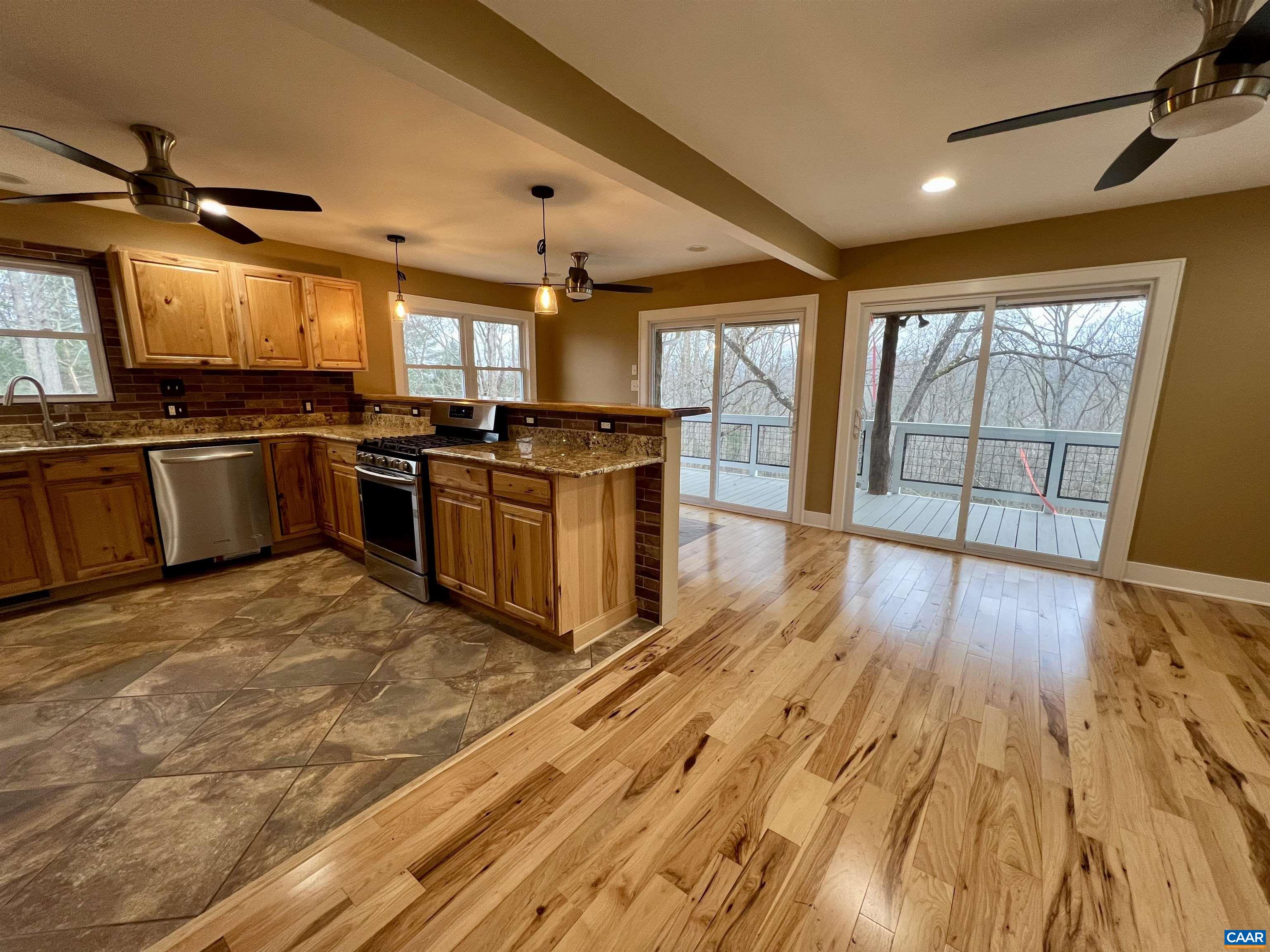 8272 Faber Road Faber, VA 22938 - Photo 5 of 44 a large kitchen with stainless steel appliances granite countertop a stove and a wooden floors