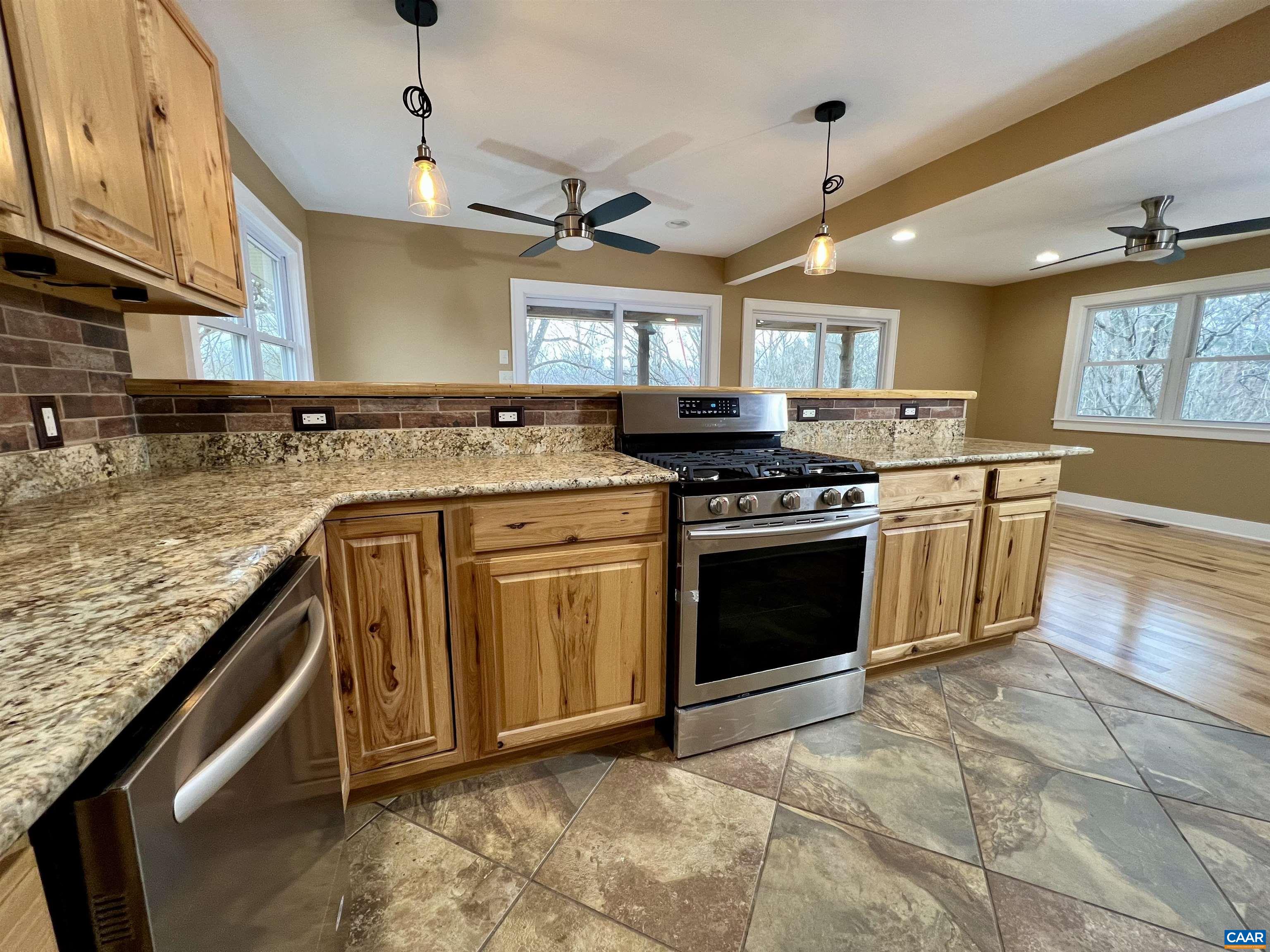 8272 Faber Road Faber, VA 22938 - Photo 7 of 44 a kitchen with stainless steel appliances granite countertop a stove a sink and a microwave