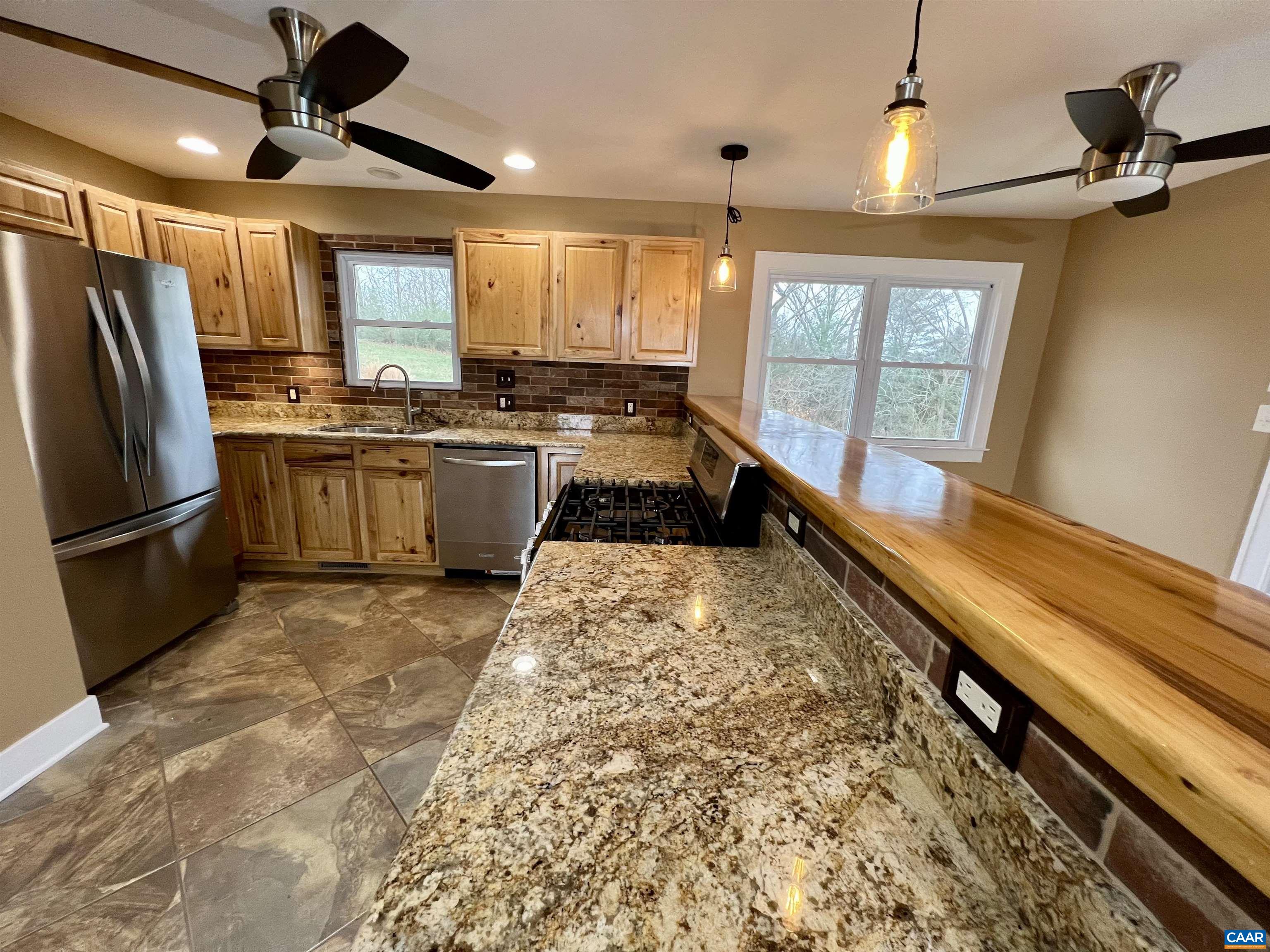 8272 Faber Road Faber, VA 22938 - Photo 8 of 44 a large kitchen with a large window and stainless steel appliances
