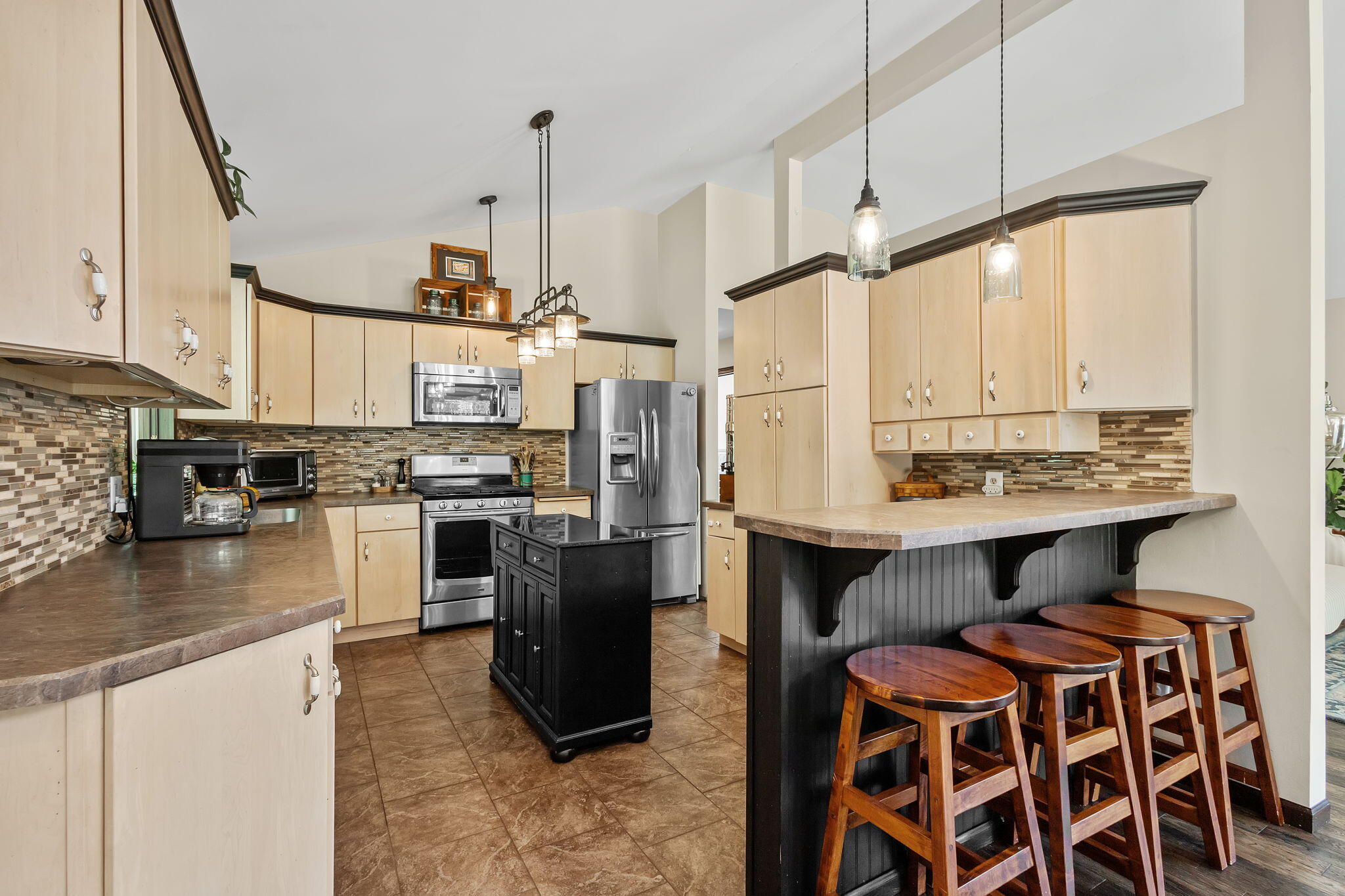 5592 East 1100th Street North Demotte, IN 46310 - Photo 12 of 77 a kitchen with stainless steel appliances granite countertop a stove a sink and a refrigerator
