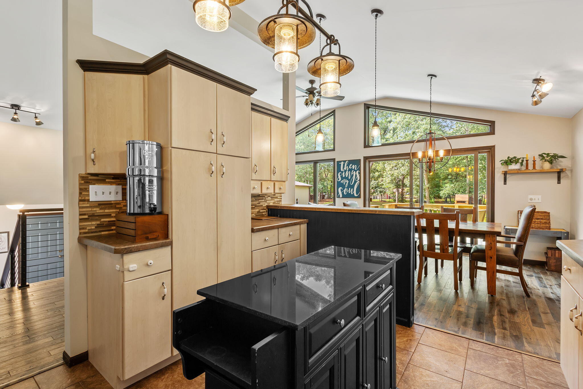 5592 East 1100th Street North Demotte, IN 46310 - Photo 13 of 77 a kitchen with stainless steel appliances granite countertop a stove a refrigerator a dining table and chairs with wooden floor