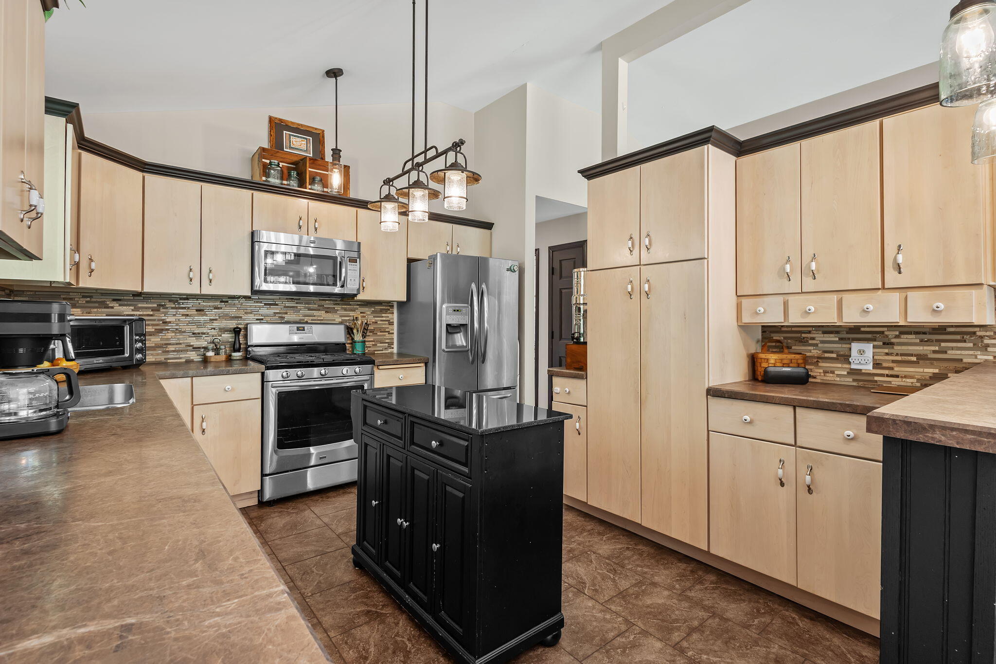 5592 East 1100th Street North Demotte, IN 46310 - Photo 15 of 77 a kitchen with stainless steel appliances granite countertop a refrigerator a stove and a sink