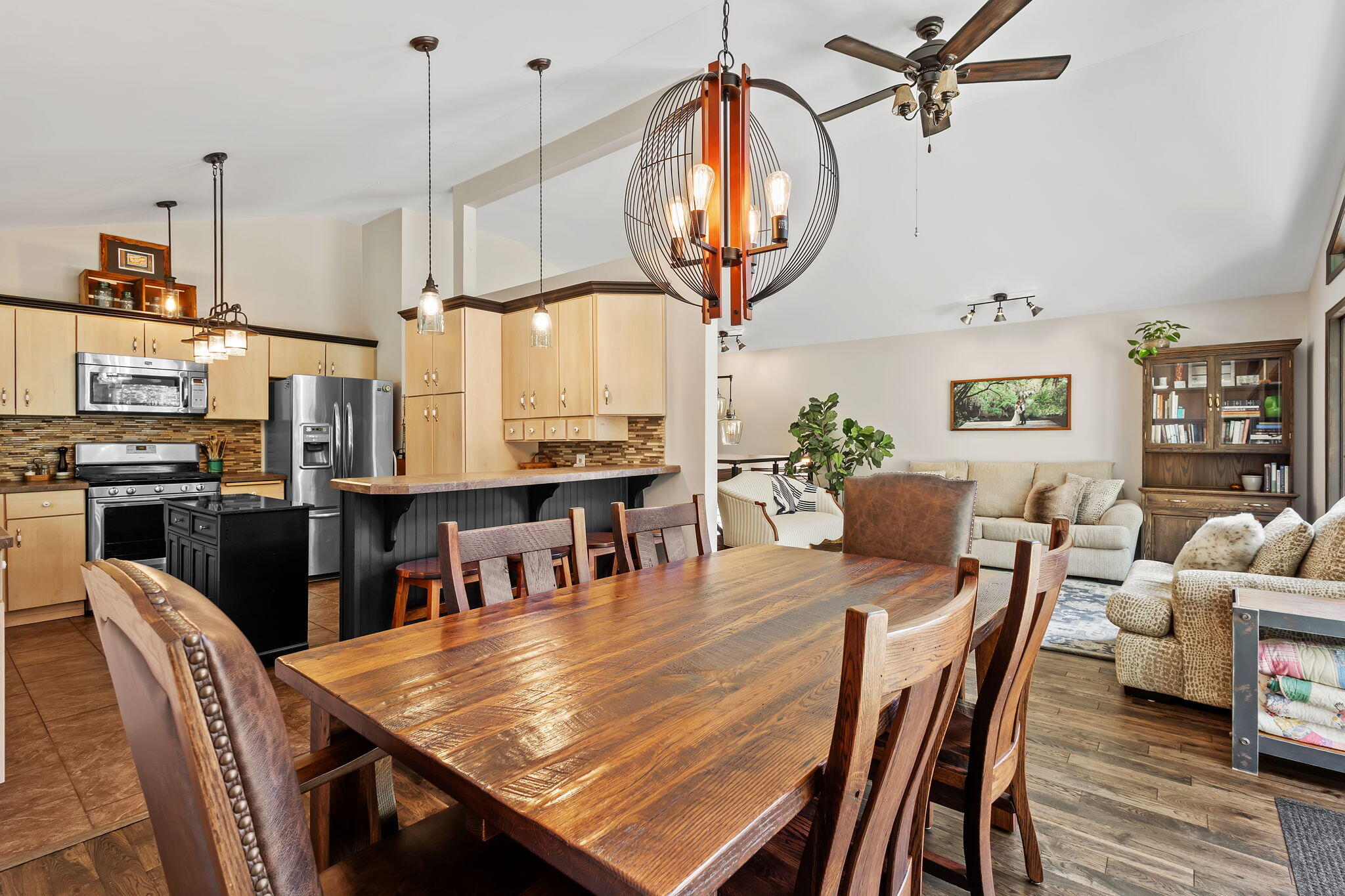 5592 East 1100th Street North Demotte, IN 46310 - Photo 18 of 77 a dining room with furniture a kitchen view and a chandelier