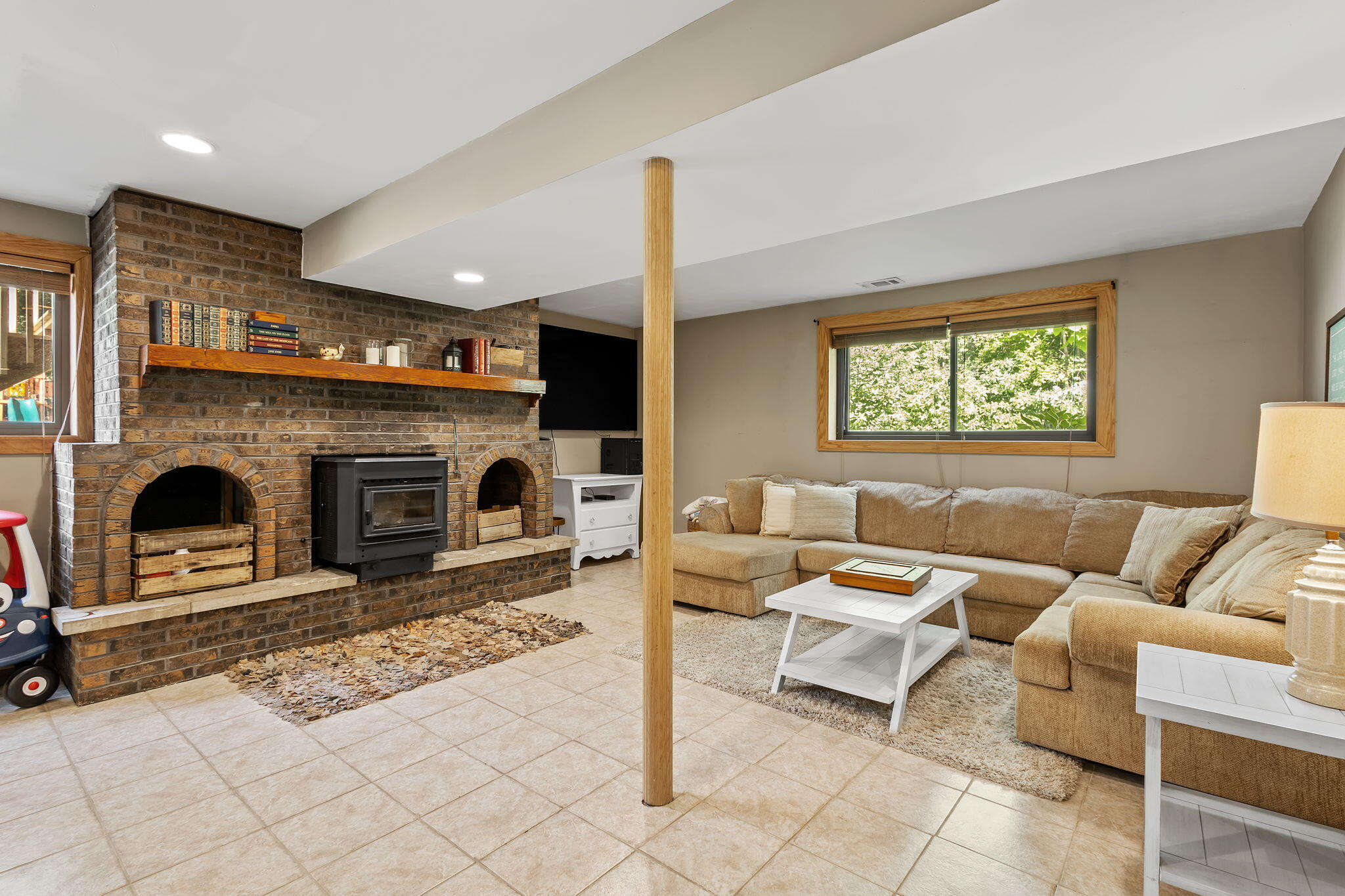 5592 East 1100th Street North Demotte, IN 46310 - Photo 36 of 77 a living room with furniture a fireplace and a flat screen tv
