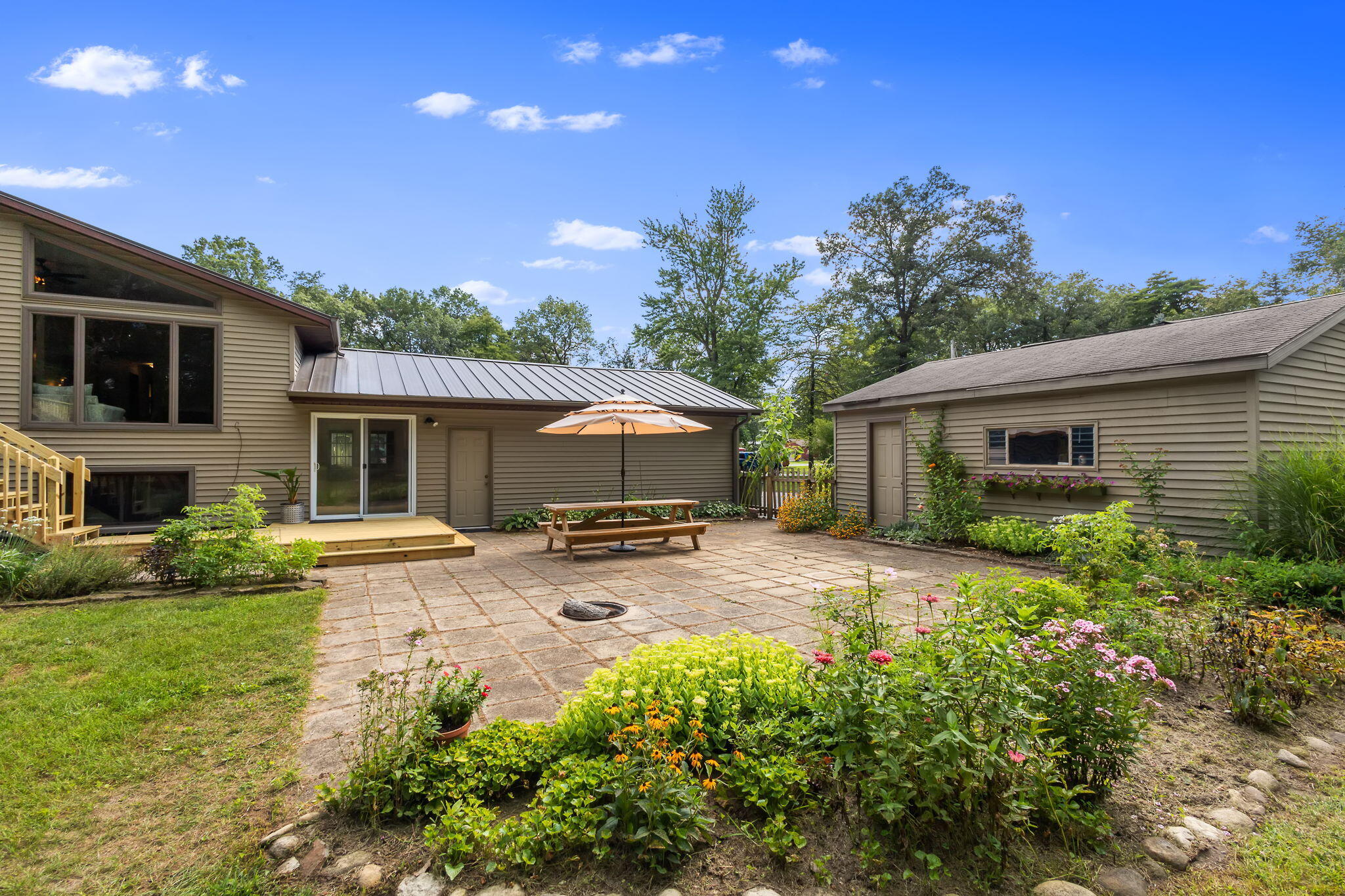 5592 East 1100th Street North Demotte, IN 46310 - Photo 53 of 77 a view of a house with backyard and sitting area
