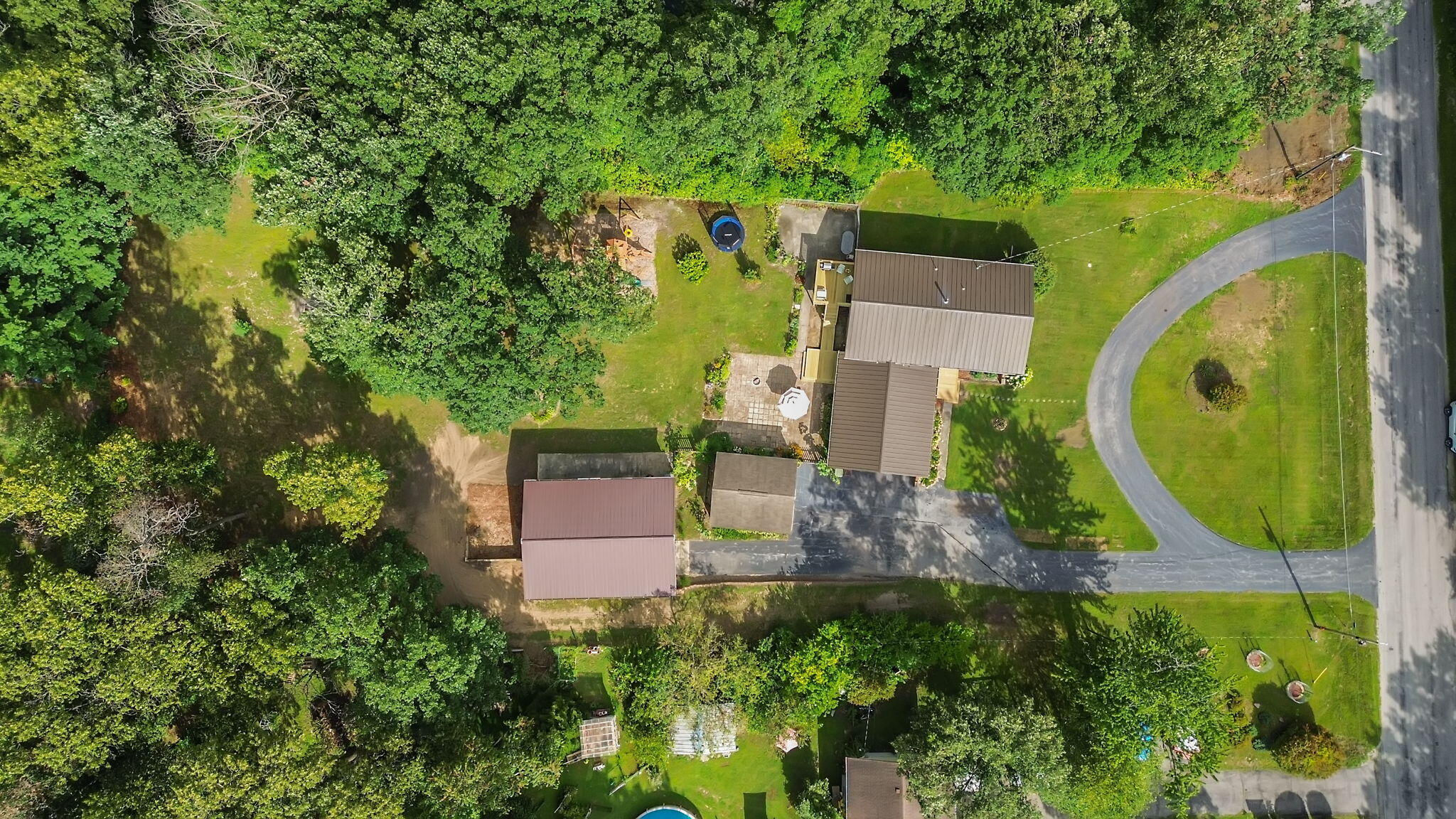 5592 East 1100th Street North Demotte, IN 46310 - Photo 61 of 77 an aerial view of a house with a garden and trees