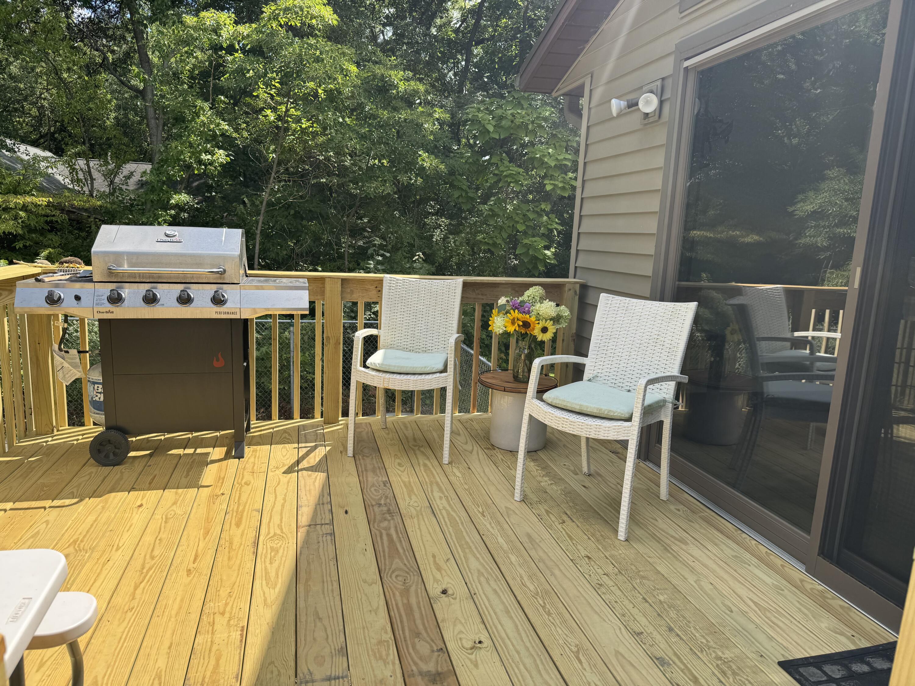 5592 East 1100th Street North Demotte, IN 46310 - Photo 71 of 77 a view of a patio with table and chairs a barbeque with wooden floor and fence