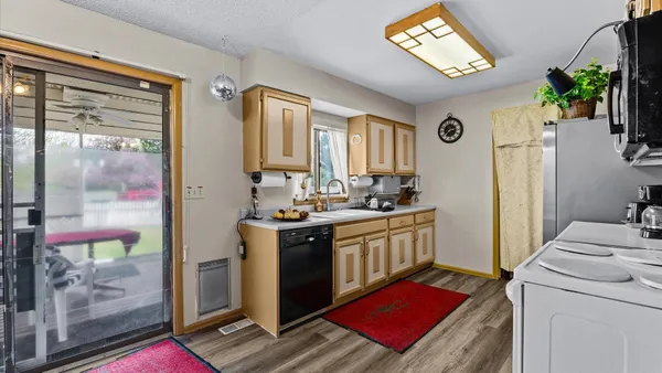 a kitchen with a sink stove and refrigerator